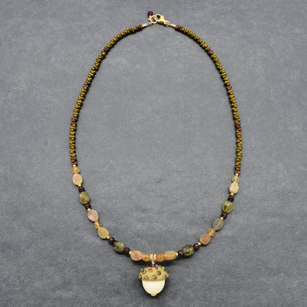 Forest Fable Necklace featuring artisan lampwork glass acorn focal with green garnet, red garnet and citrine, handmade by Ruby Acorn