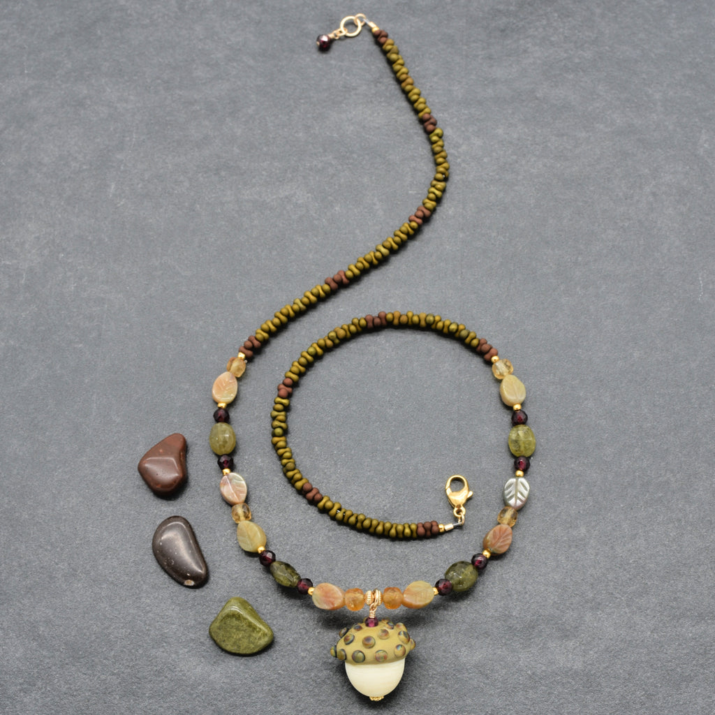 Forest Fable Necklace featuring artisan lampwork glass acorn focal with green garnet, red garnet and citrine, handmade by Ruby Acorn