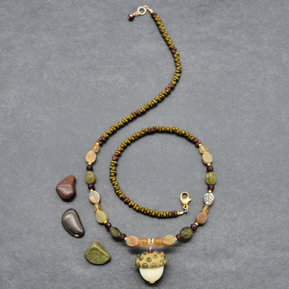 Forest Fable Necklace featuring artisan lampwork glass acorn focal with green garnet, red garnet and citrine, handmade by Ruby Acorn