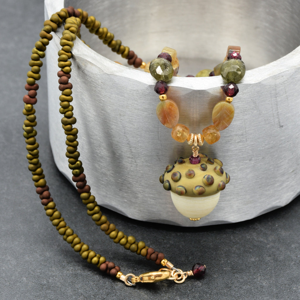 Forest Fable Necklace featuring artisan lampwork glass acorn focal with green garnet, red garnet and citrine, handmade by Ruby Acorn