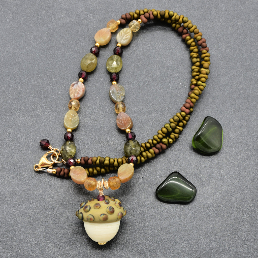 Forest Fable Necklace featuring artisan lampwork glass acorn focal with green garnet, red garnet and citrine, handmade by Ruby Acorn
