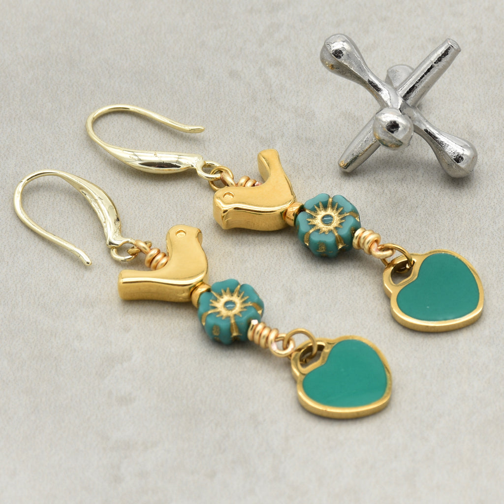 Lovebirds Turquoise Blue dangle earrings with gold birds and heart charms on a light background - handmade with love by Ruby Acorn