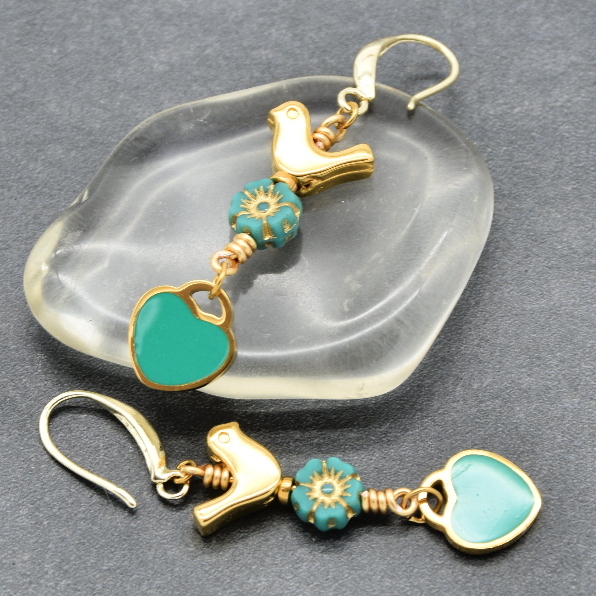 Lovebirds Turquoise Blue dangle earrings with gold birds and heart charms on a gray background - handmade with love by Ruby Acorn