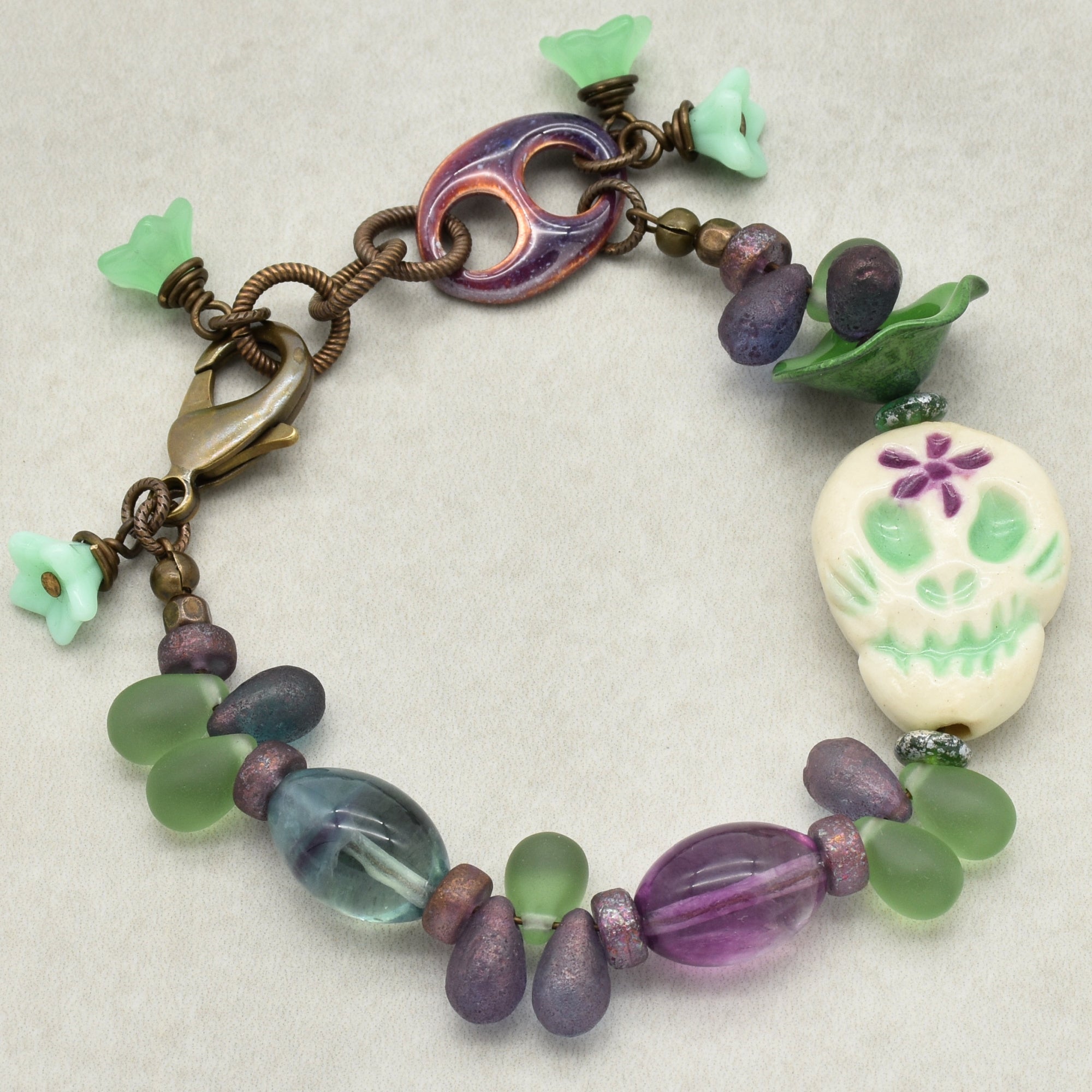 Fabulous Purple and Green Mardi Gras Catrina Handmade Beaded Bracelet with Artisan Ceramic Sugar Skull, Artisan Enameled Link and Rainbow Fluorite