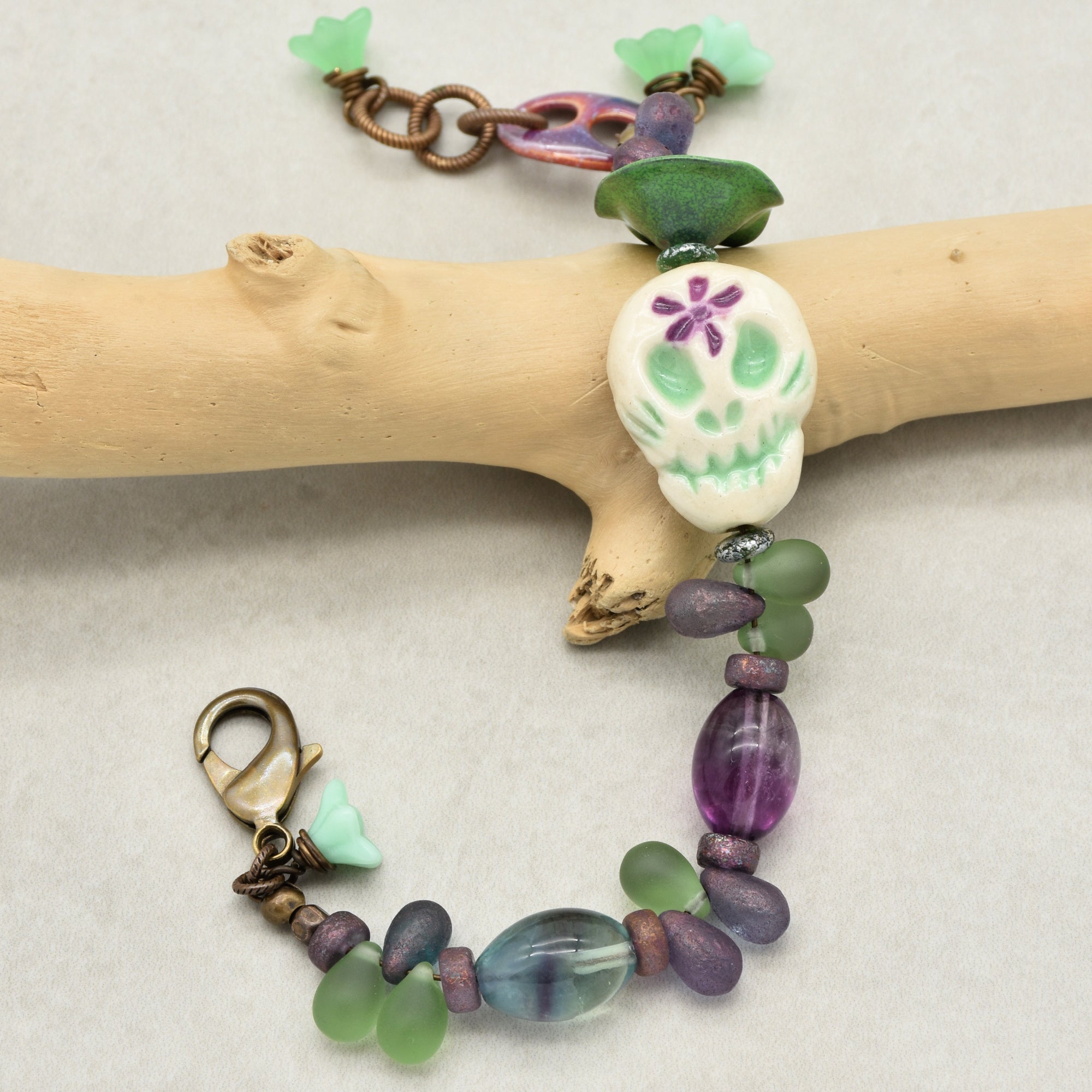 Fabulous Purple and Green Mardi Gras Catrina Handmade Beaded Bracelet with Artisan Ceramic Sugar Skull, Artisan Enameled Link and Rainbow Fluorite
