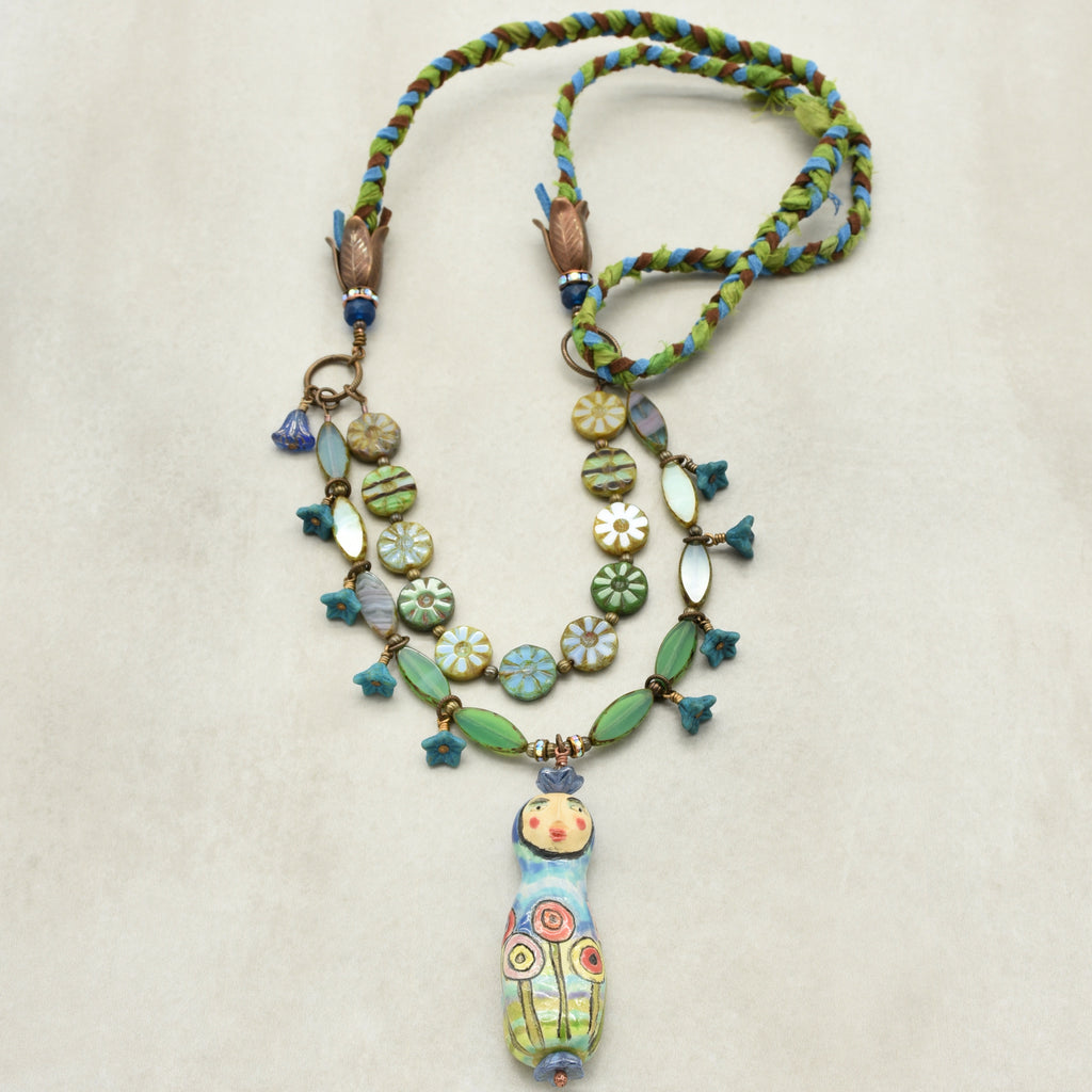 Colorful beaded necklace with a unique pendant on a light background
