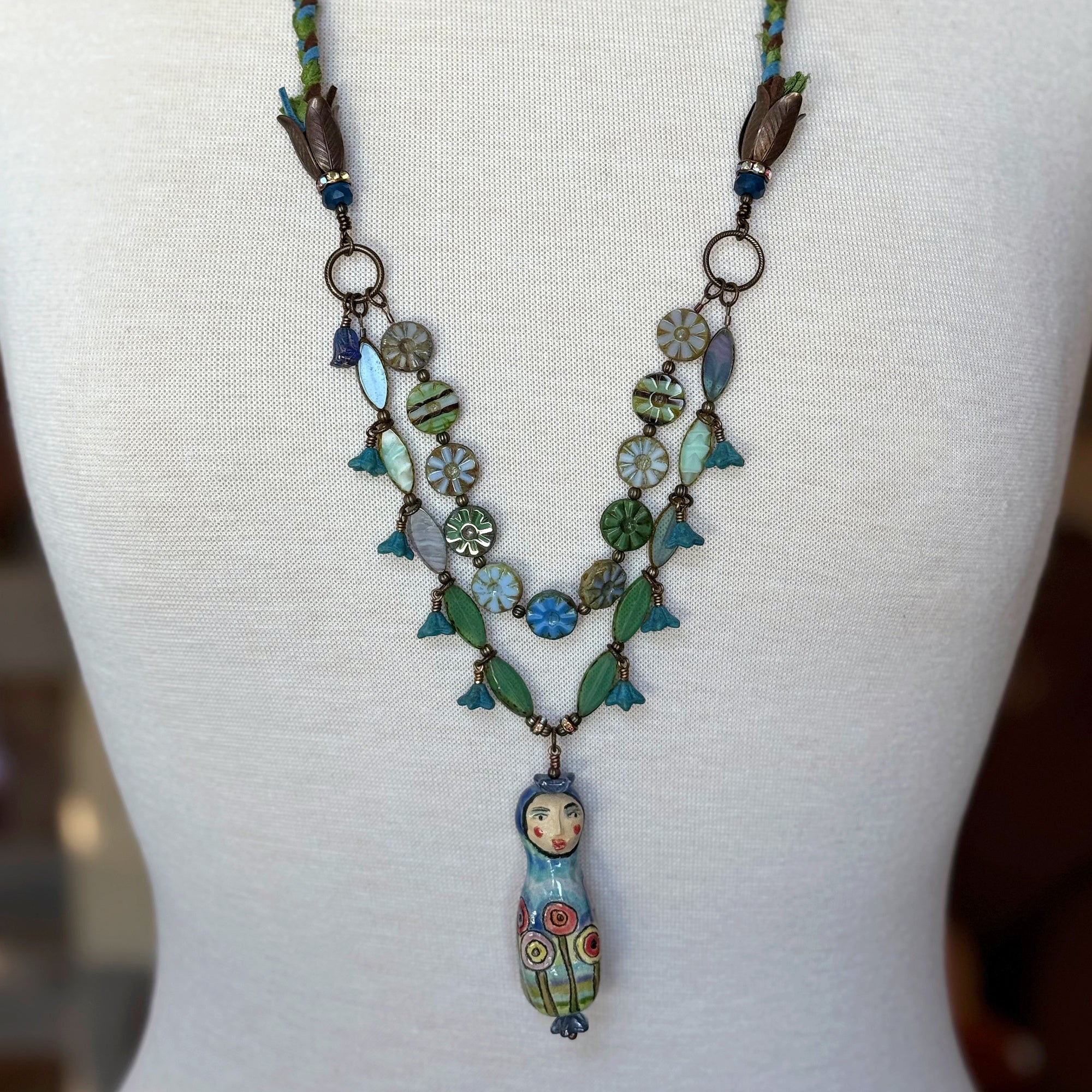 Necklace with decorative pendant on a mannequin