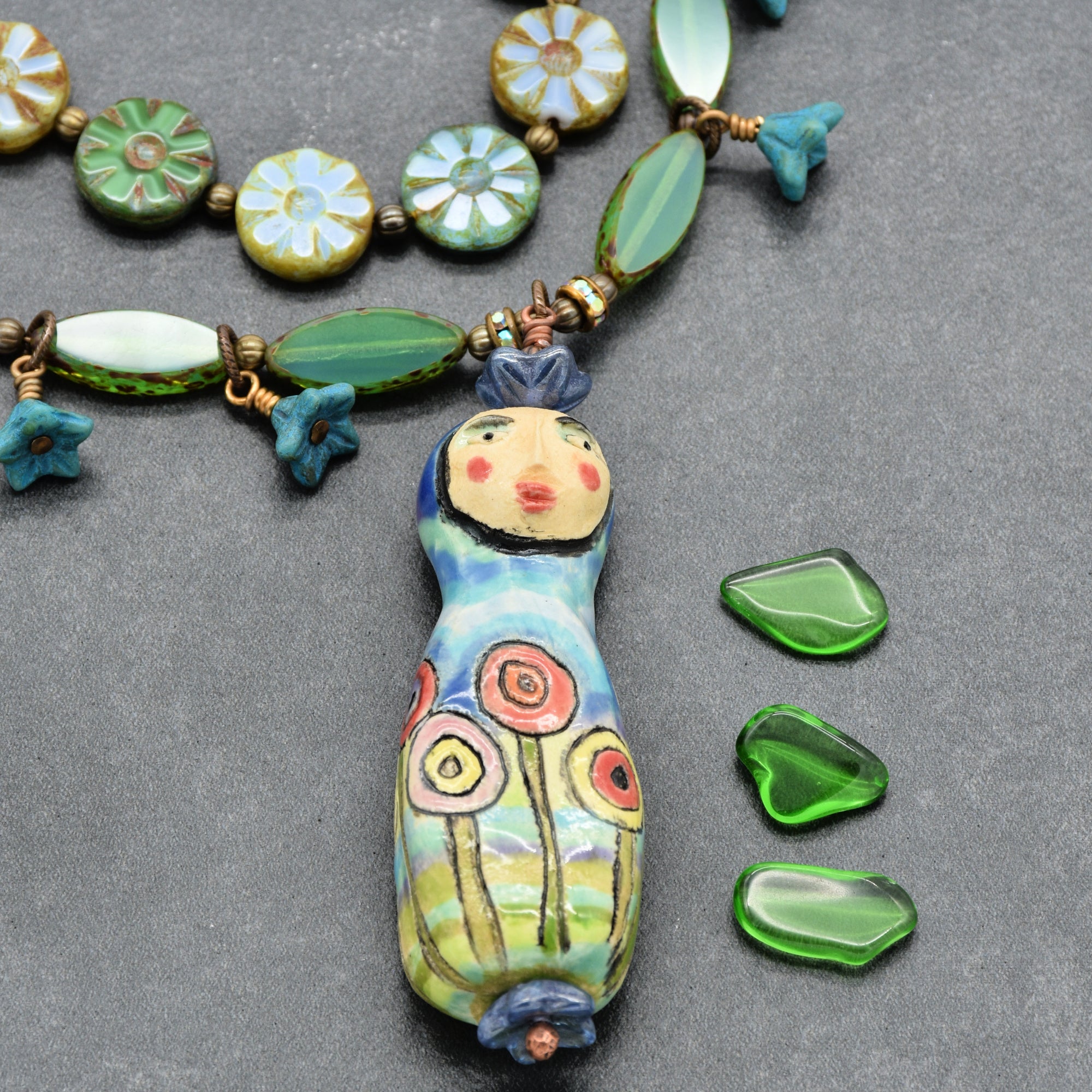 Necklace with a decorative pendant on a gray surface