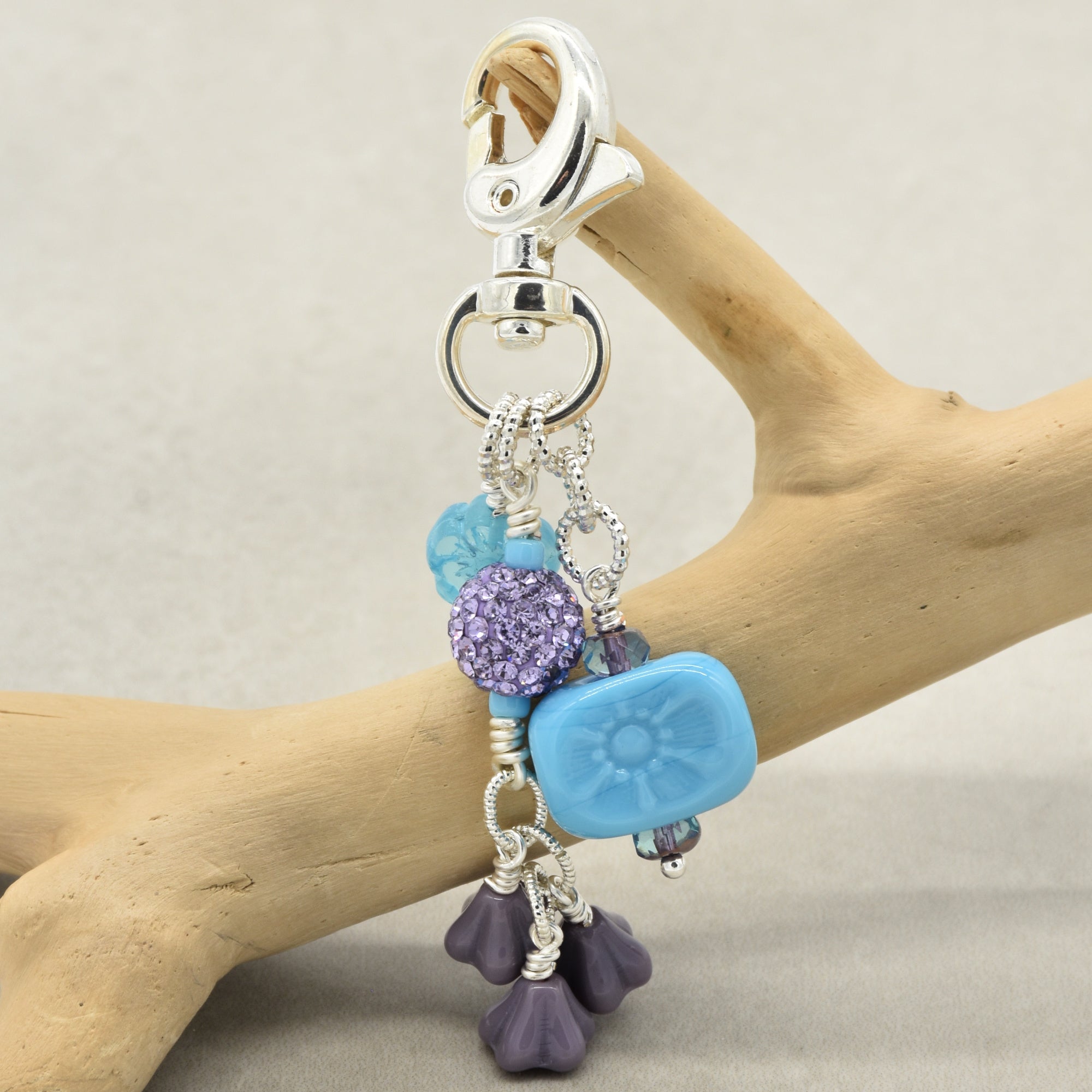 Keychain with blue and purple charms on a branch