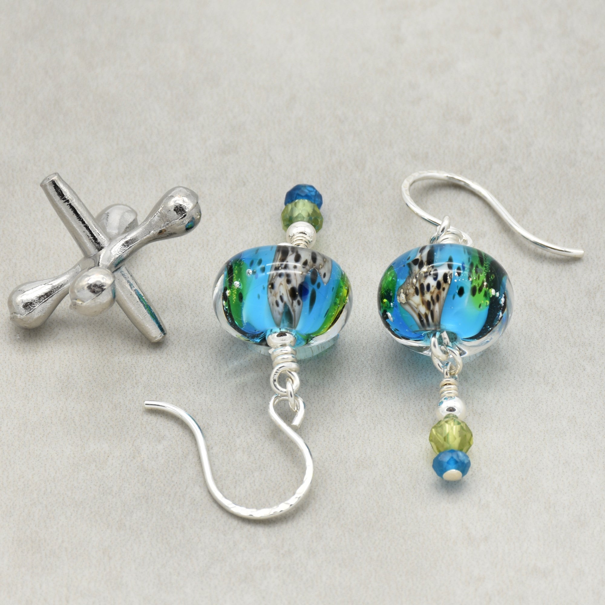 Colorful artisan lampwork glass earrings with sterling silver ear wires, peridot and apatite on a light surface - handmade with love by Ruby Acorn