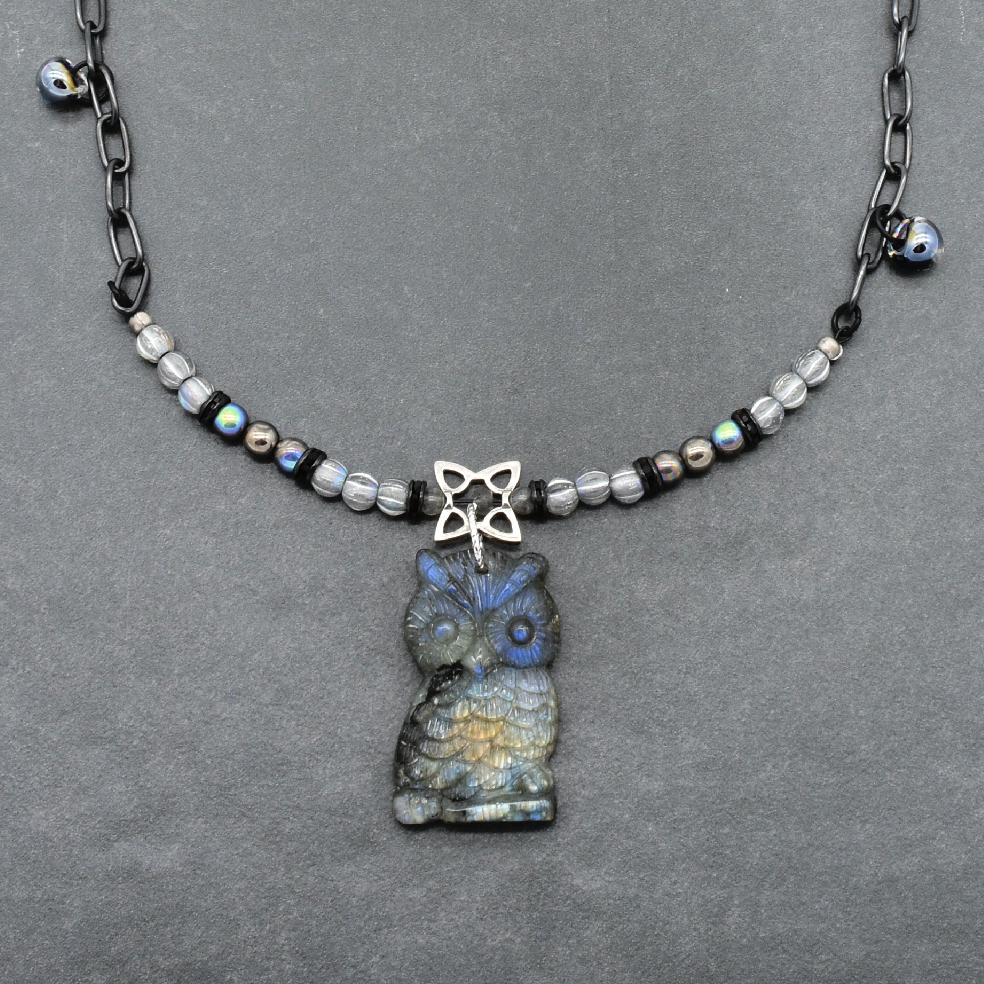 Close up of a necklace with a labradorite carved owl focal, Czech glass and noir chain - made with love in Colorado by Ruby Acorn