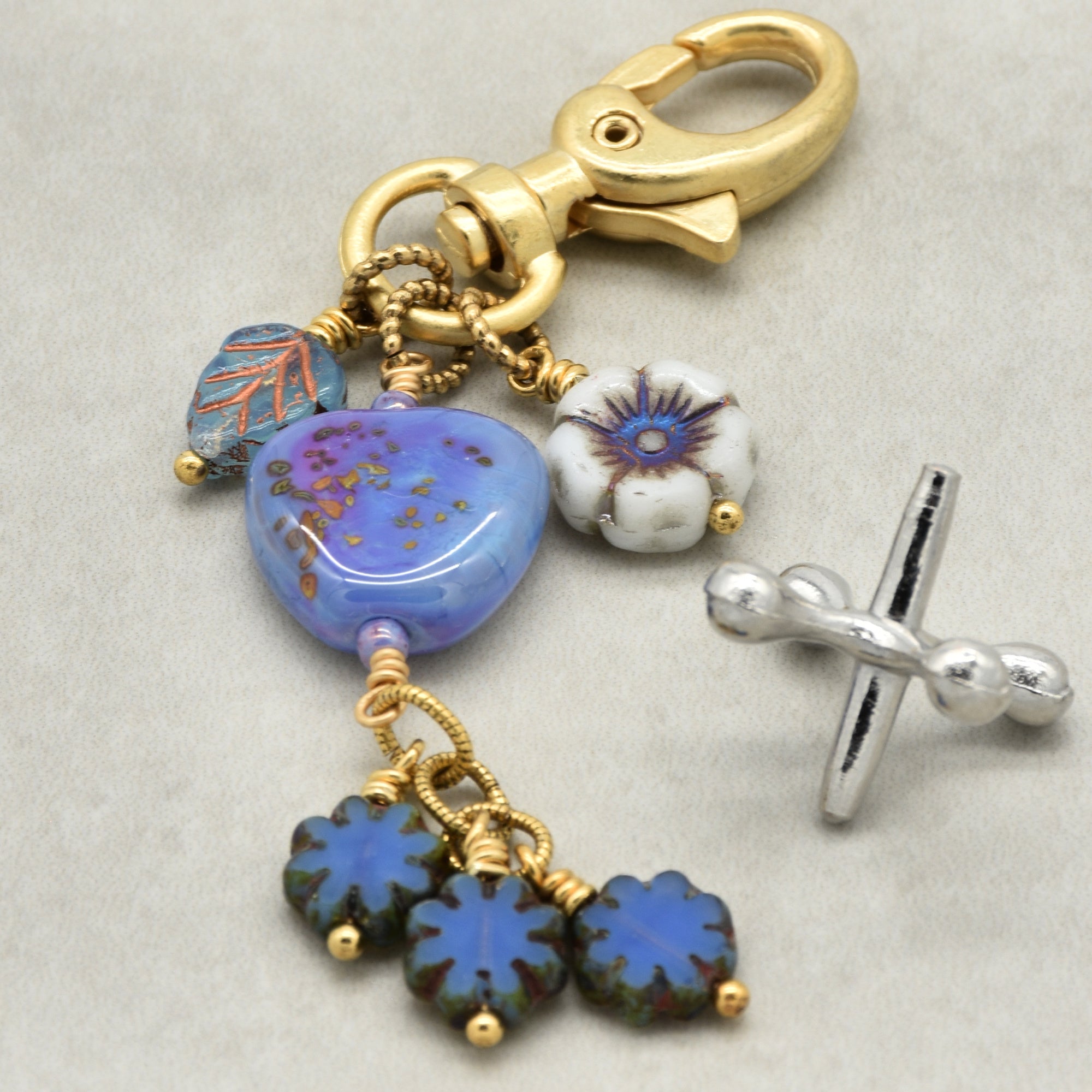 Keychain with blue and gold beads on a light gray background