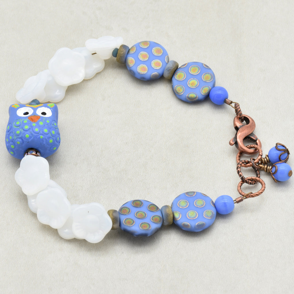 Bracelet with periwinkle and white beads on a light background