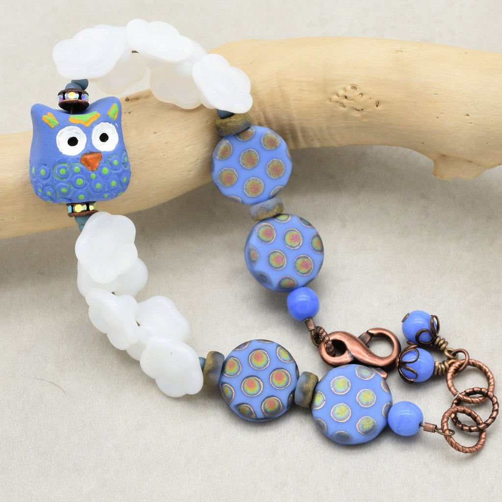 Colorful beaded bracelet with an owl focal on a wooden stick