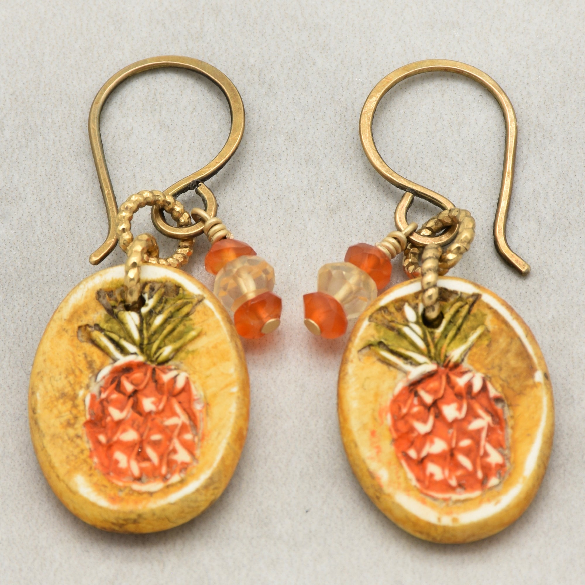 Handmade Pineapple charm earrings with brass ear wires on a light surface - made with love by Ruby Acorn