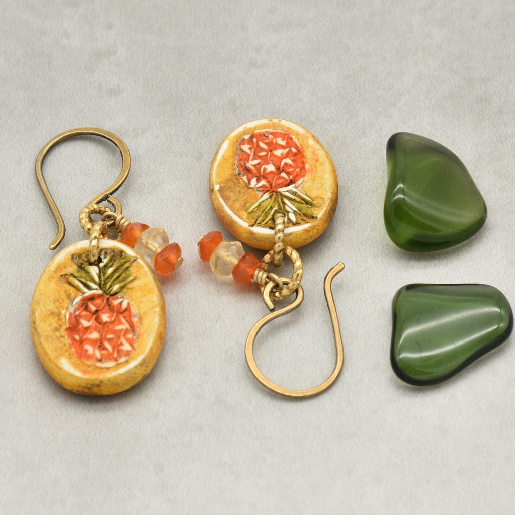 Handmade Pineapple charm earrings with brass ear wires on a light surface - made with love by Ruby Acorn