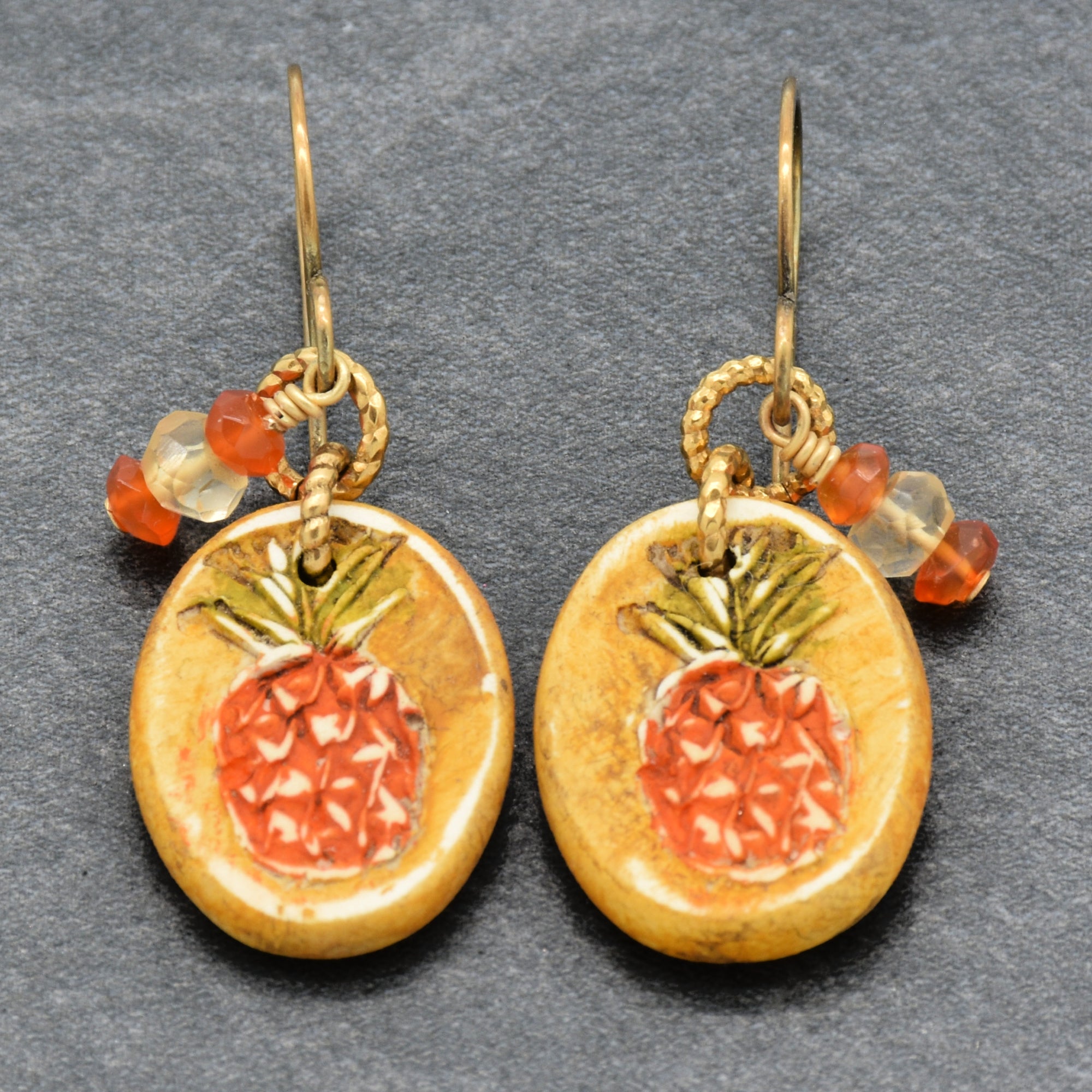 Handmade Pineapple charm earrings with brass ear wires on a gray surface - made with love by Ruby Acorn