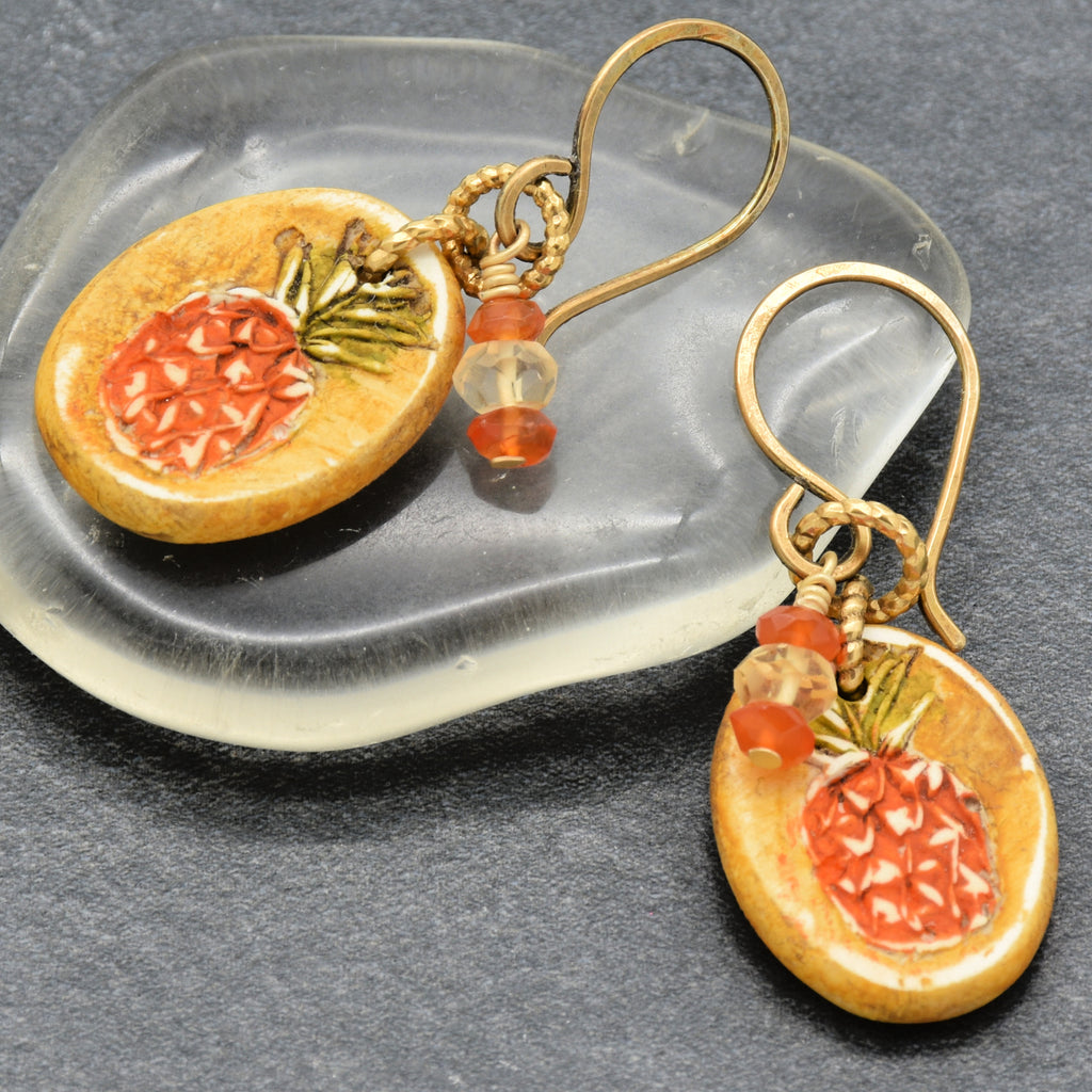 Handmade Pineapple charm earrings with brass ear wires on a gray surface - made with love by Ruby Acorn