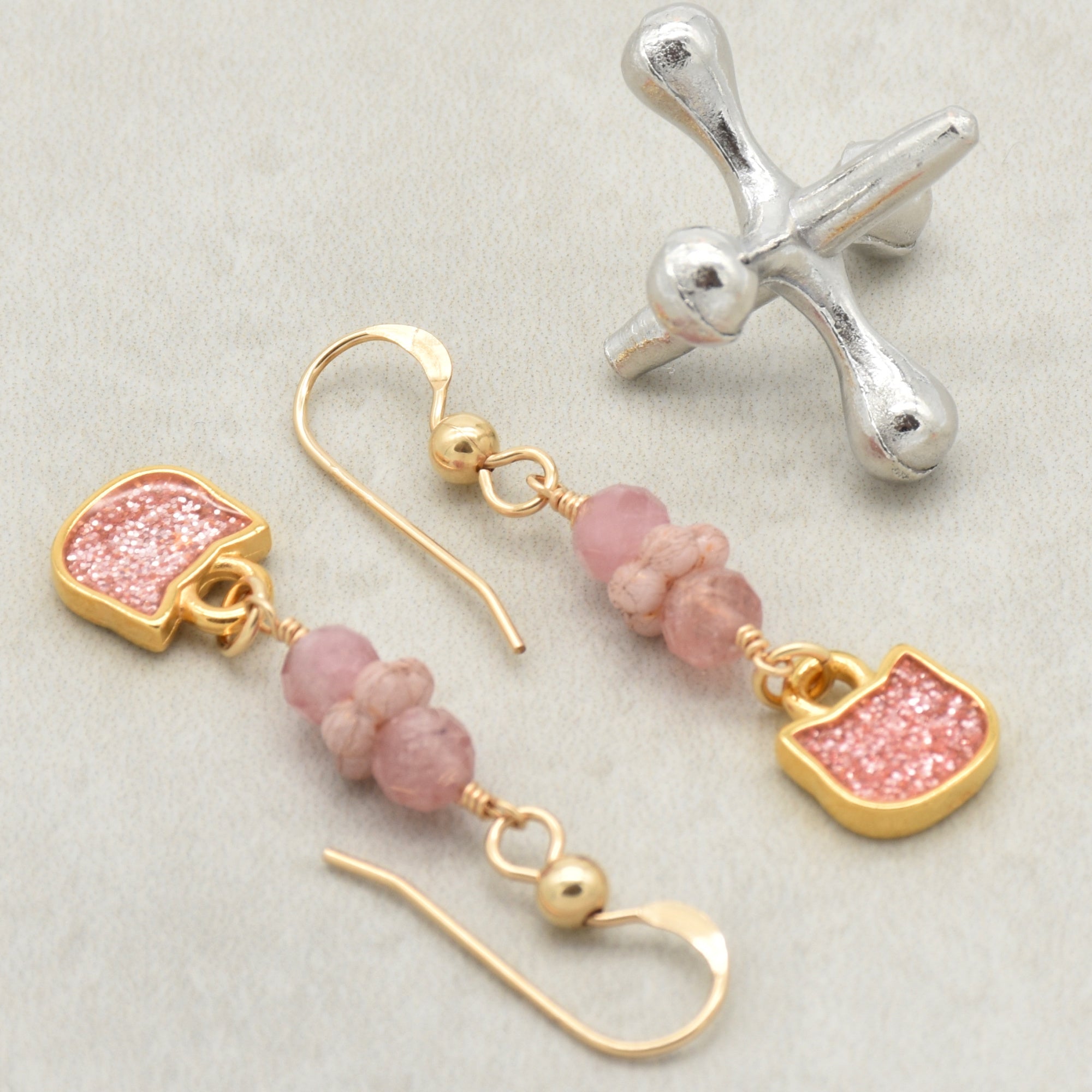 Lovely delicate pink dangle earrings with cat charms, pink tourmaline, and gold ear wires on a light background - handmade with love by Ruby Acorn