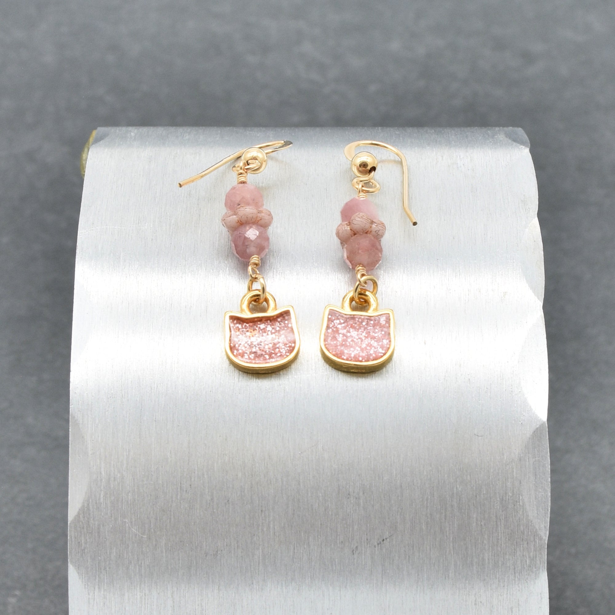 Lovely delicate pink dangle earrings with cat charms, pink tourmaline, and gold ear wires on a silver background - handmade with love by Ruby Acorn