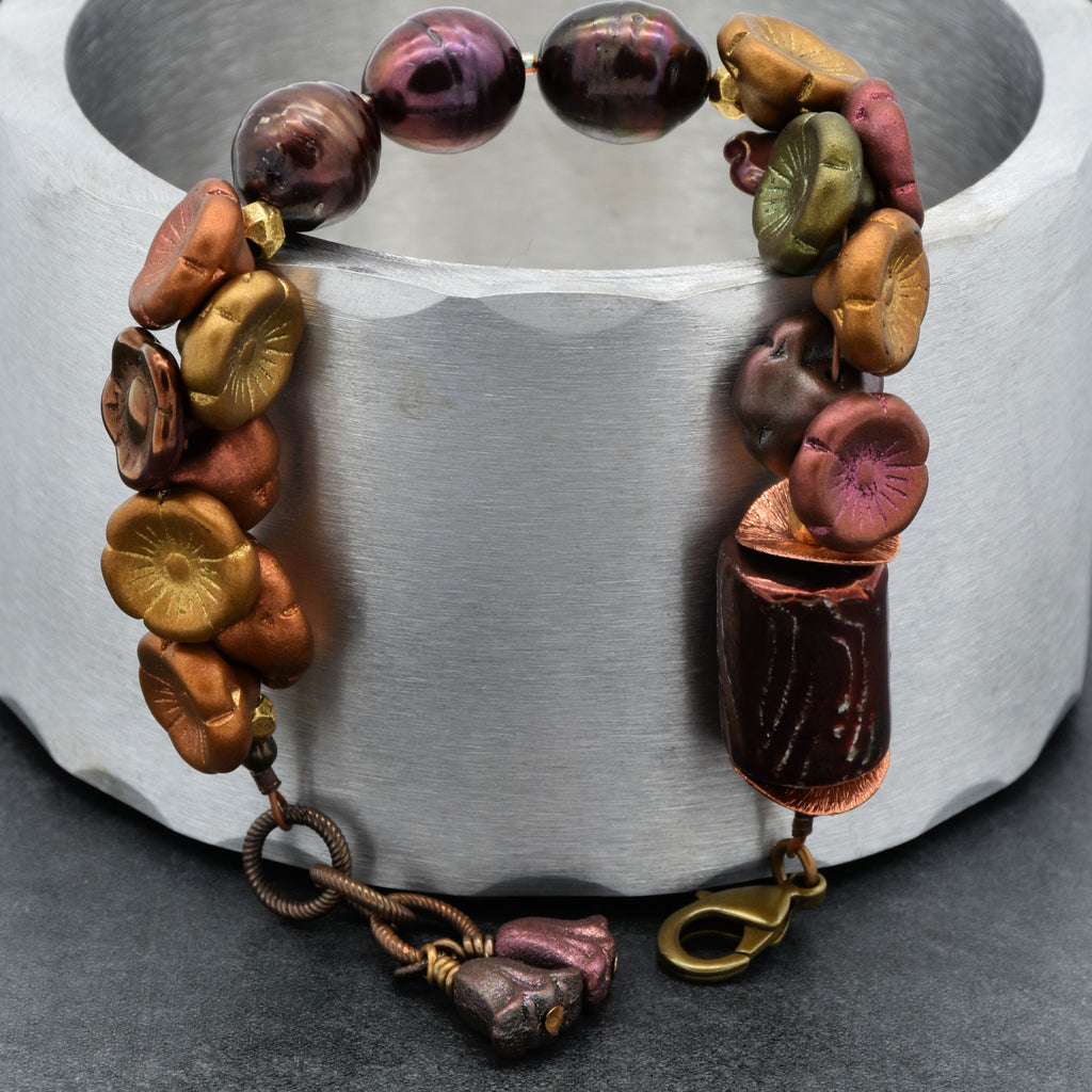 Multicolored beaded bracelet on a metallic surface