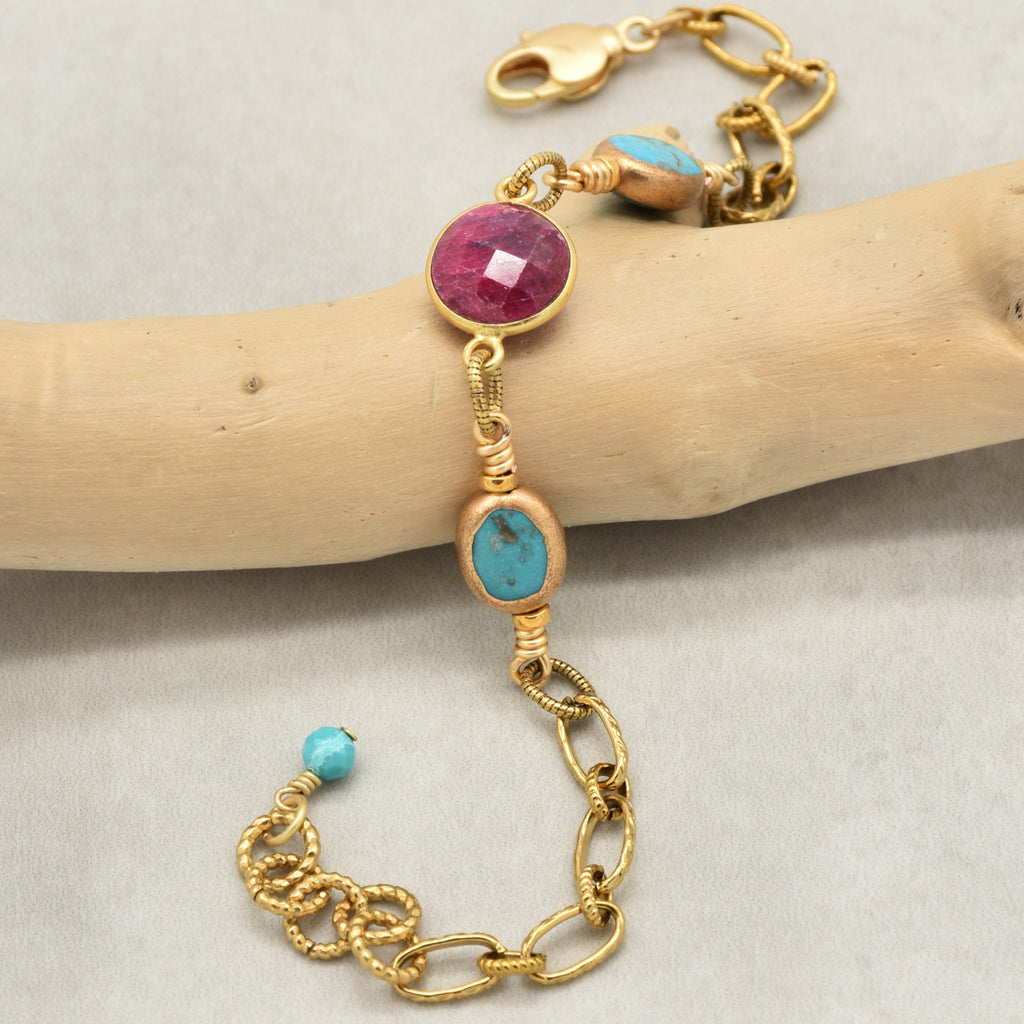 Gold chain bracelet with ruby and natural turquoise displayed on a branch - art you can wear by Ruby Acorn
