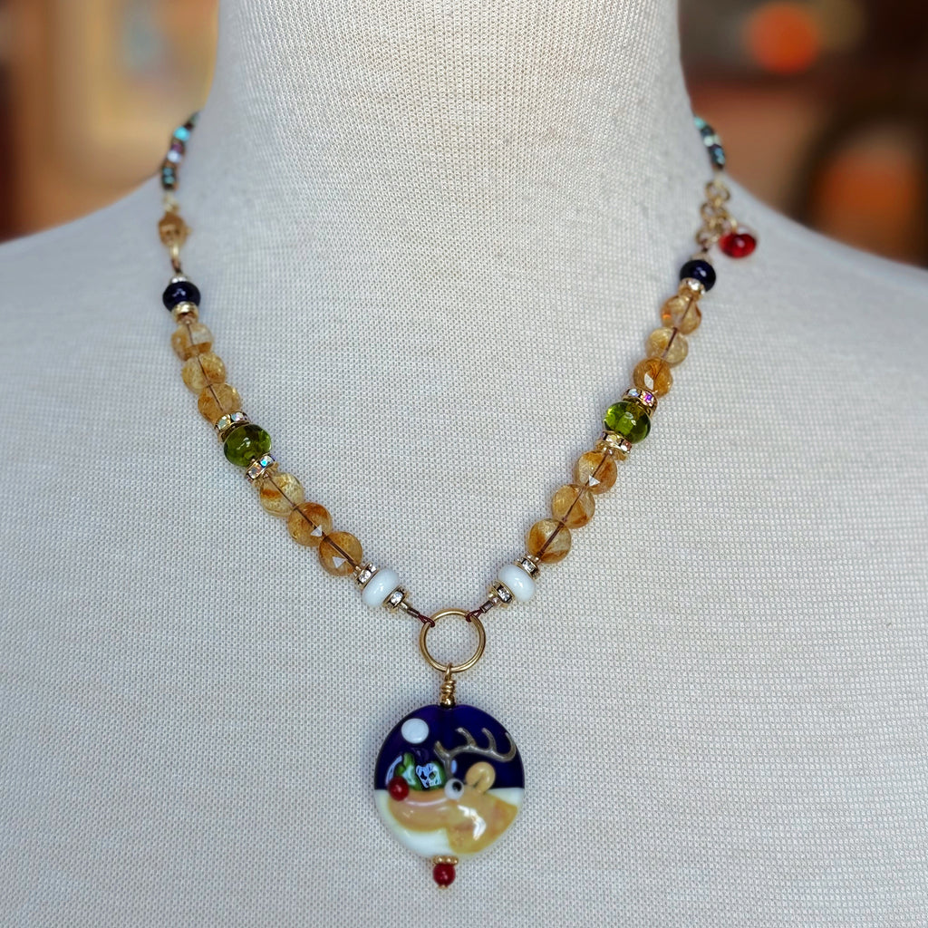 Necklace with a reindeer pendant on a mannequin