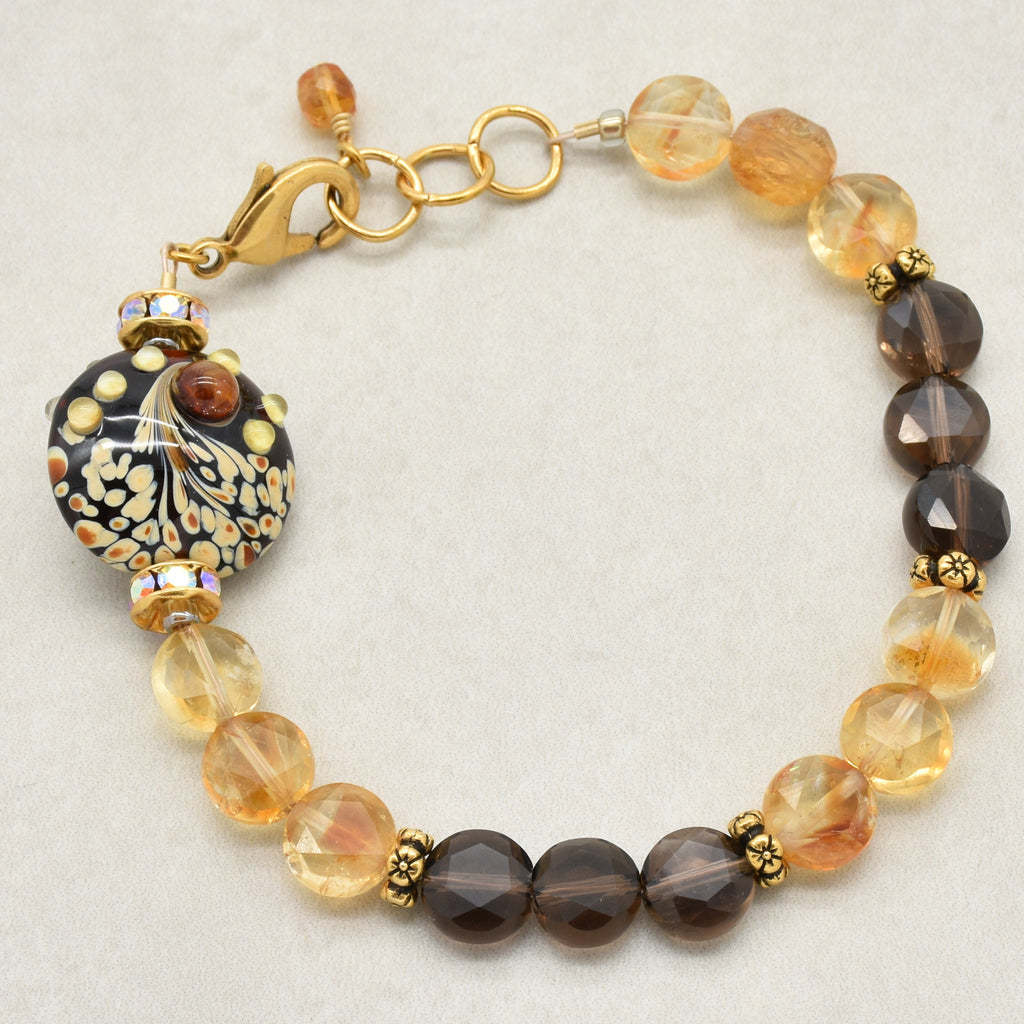Solstice Luxe Bracelet featuring artisan lampwork glass focal with smoky quartz and citrine faceted coins, handmade by Ruby Acorn