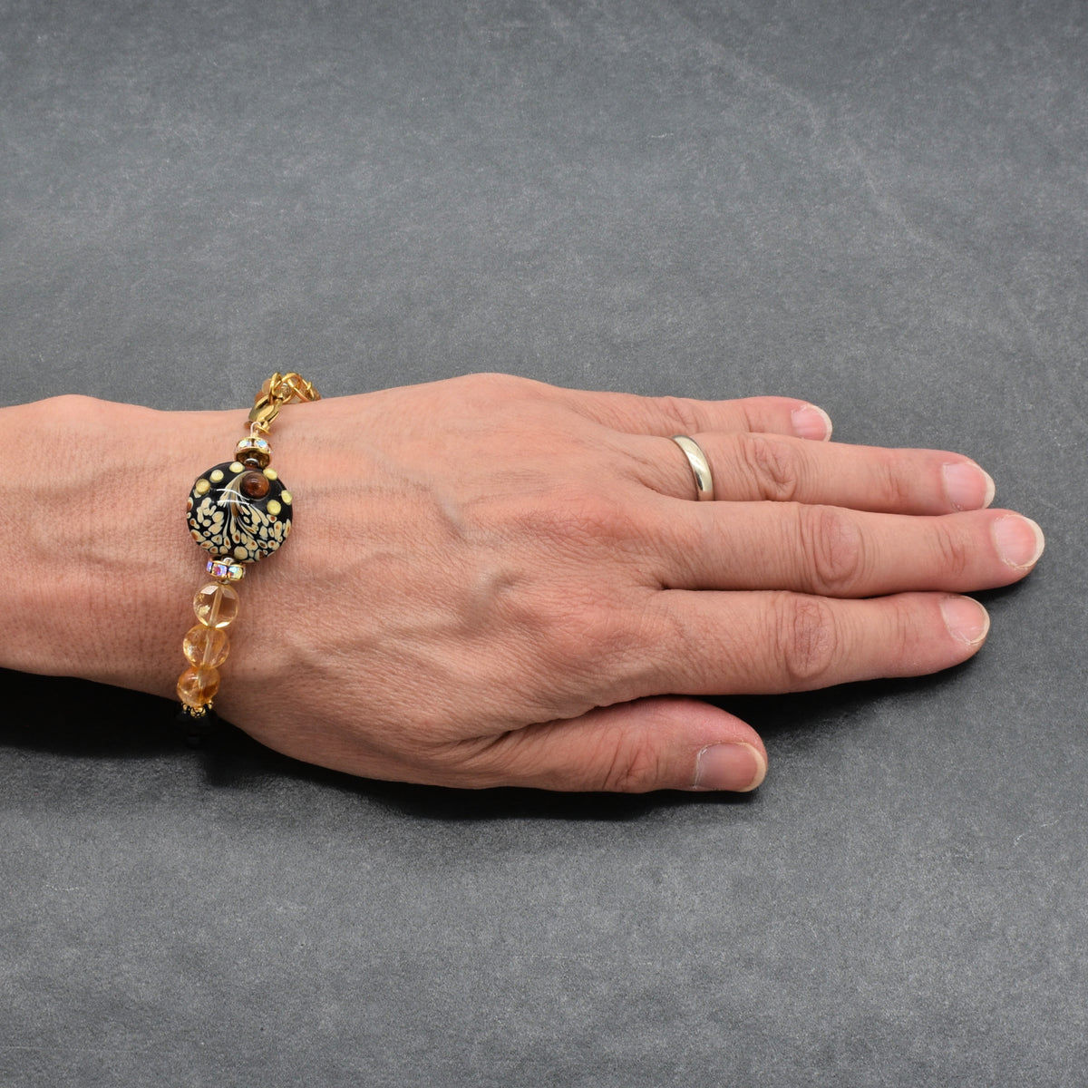 Solstice Luxe Bracelet featuring artisan lampwork glass focal with smoky quartz and citrine faceted coins, handmade by Ruby Acorn