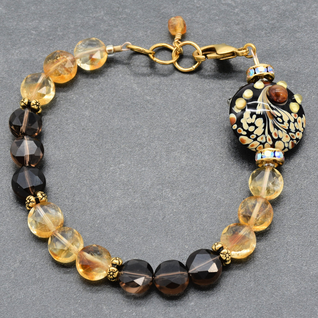 Solstice Luxe Bracelet featuring artisan lampwork glass focal with smoky quartz and citrine faceted coins, handmade by Ruby Acorn