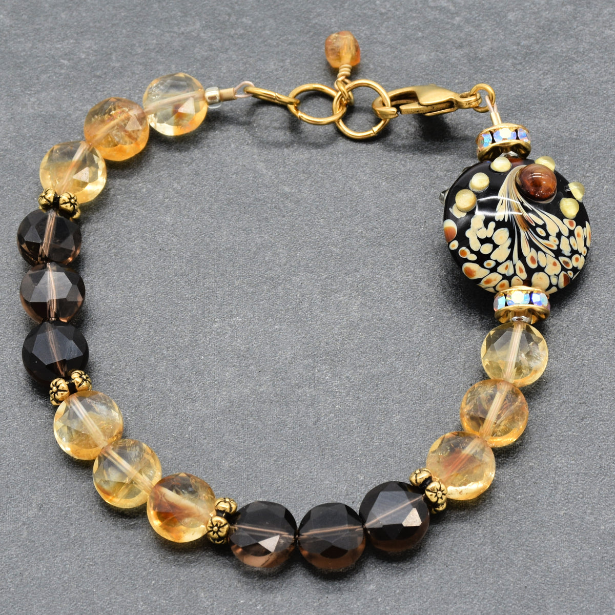 Solstice Luxe Bracelet featuring artisan lampwork glass focal with smoky quartz and citrine faceted coins, handmade by Ruby Acorn