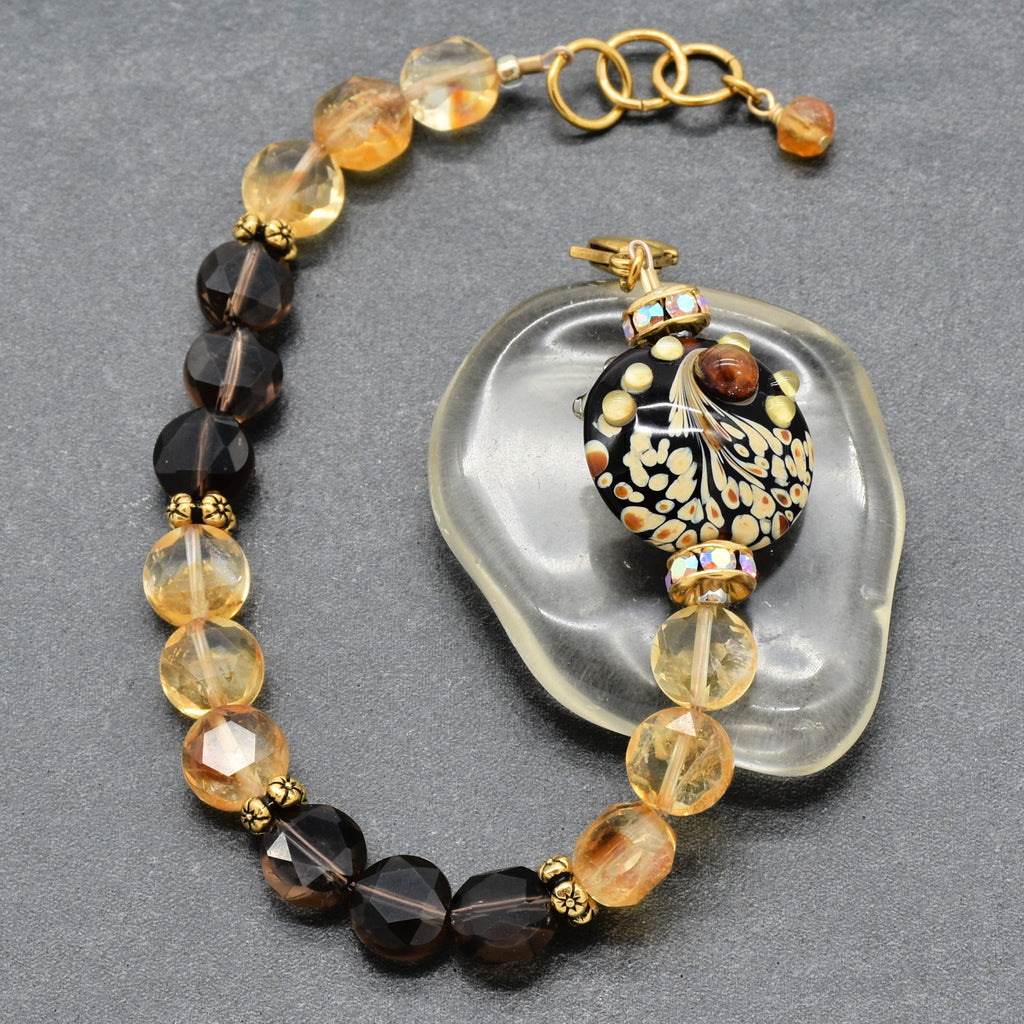 Solstice Luxe Bracelet featuring artisan lampwork glass focal with smoky quartz and citrine faceted coins, handmade by Ruby Acorn