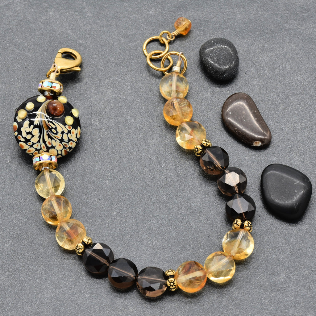 Solstice Luxe Bracelet featuring artisan lampwork glass focal with smoky quartz and citrine faceted coins, handmade by Ruby Acorn