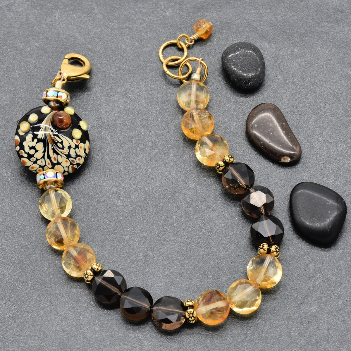 Solstice Luxe Bracelet featuring artisan lampwork glass focal with smoky quartz and citrine faceted coins, handmade by Ruby Acorn