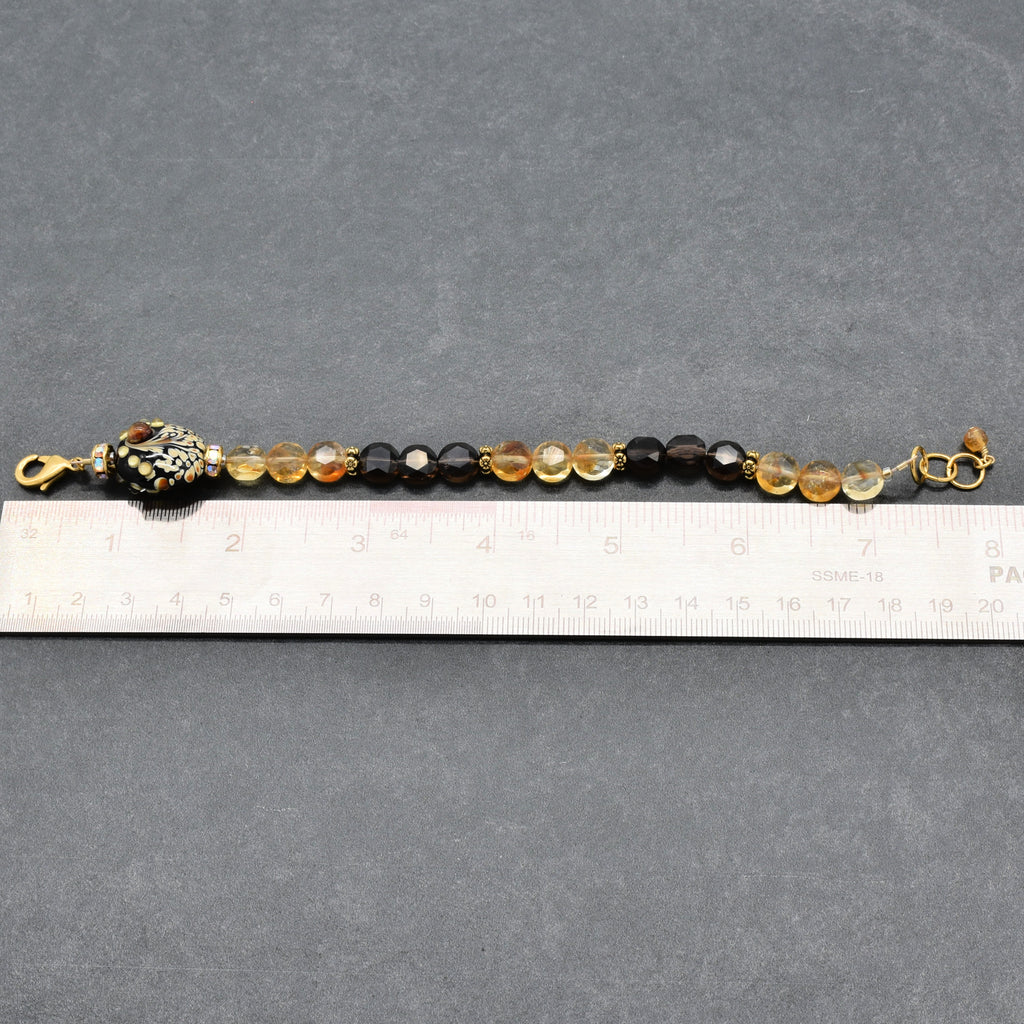 Solstice Luxe Bracelet featuring artisan lampwork glass focal with smoky quartz and citrine faceted coins, handmade by Ruby Acorn