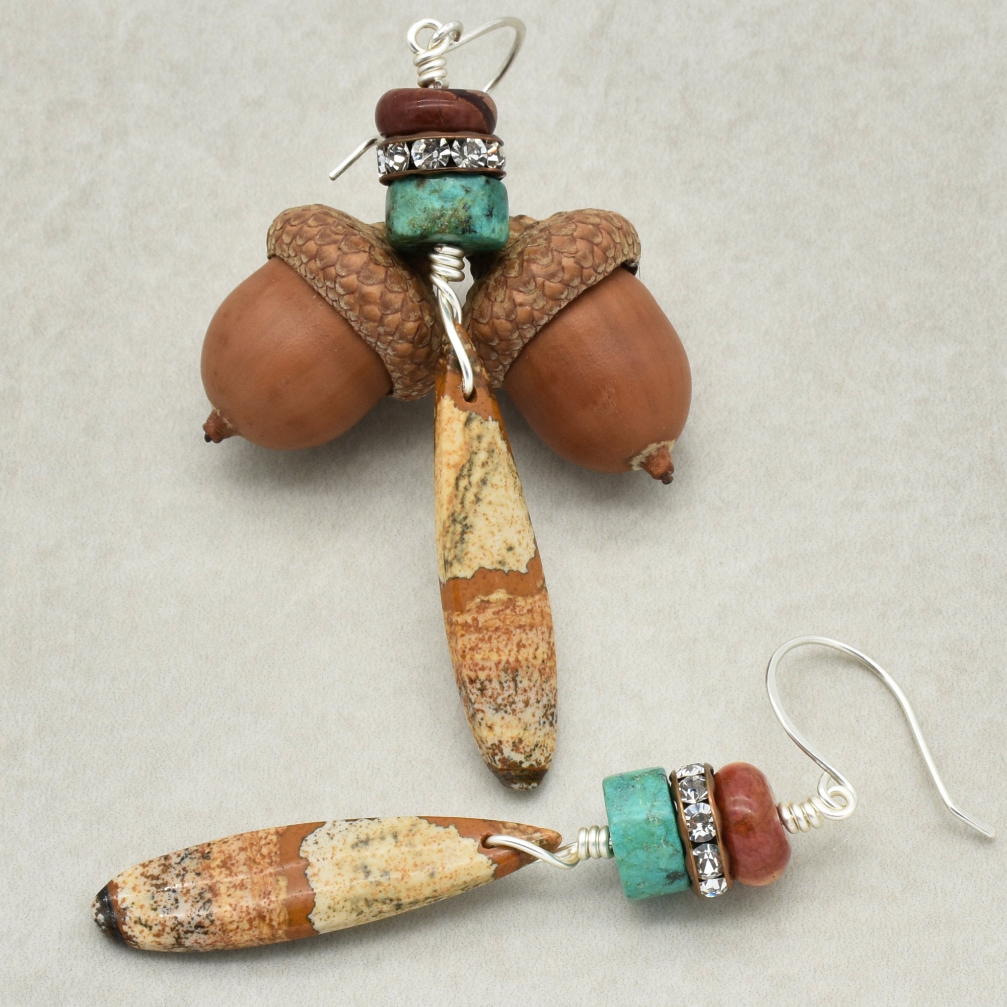 The image shows a pair of earrings. The jewelry pieces have hooks at one end, which are designed to go through pierced ears. This feature is characteristic of earrings, not necklaces or bracelets.
