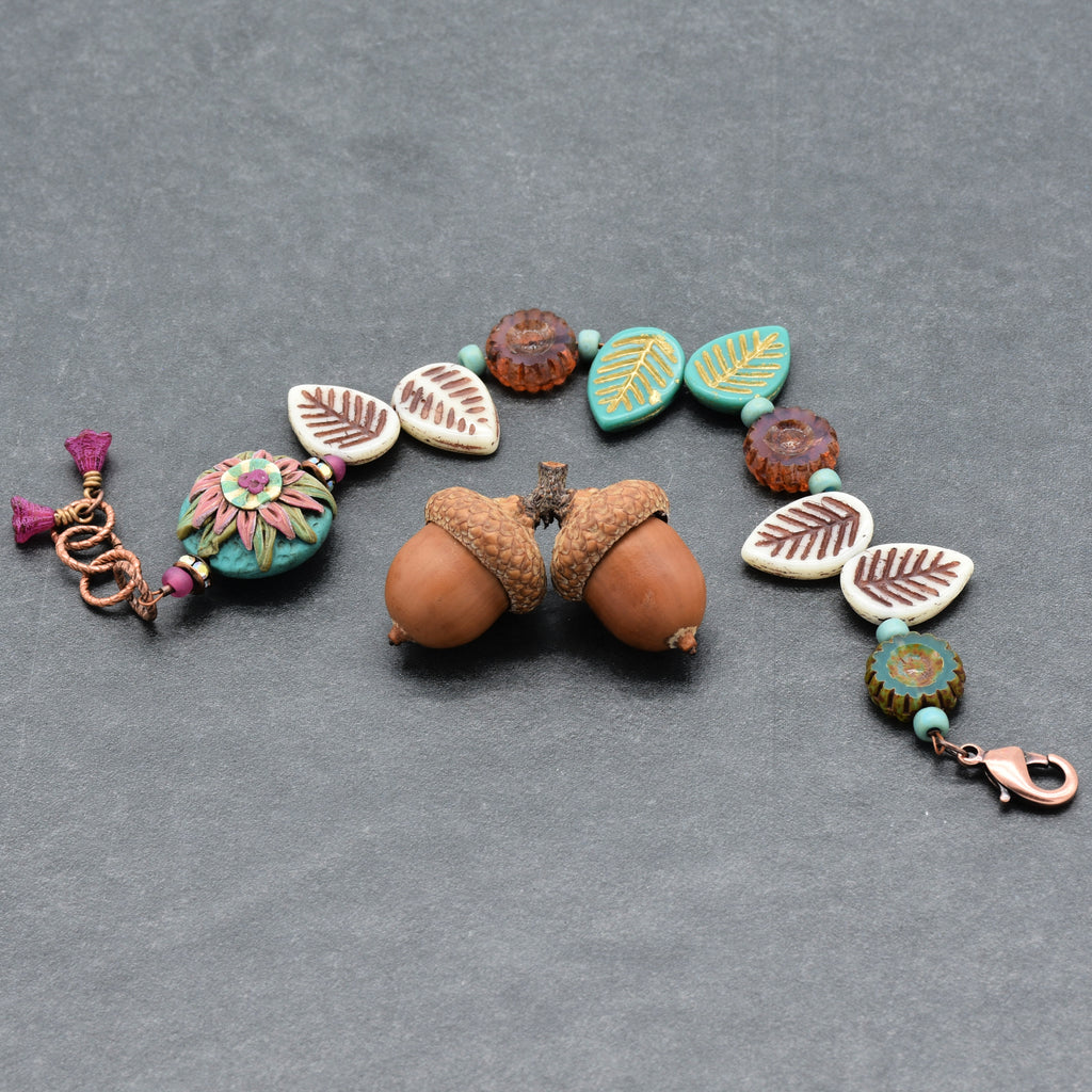 Bracelet with flower and leaf-shaped beads on a gray background