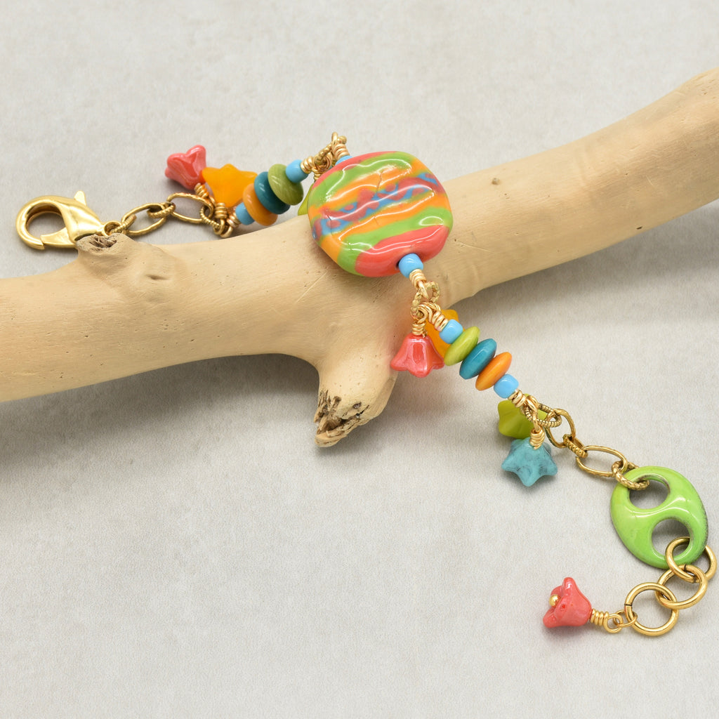 Happy colorful bracelet with African Kazuri focal, tagua nuts, and Czech glass flowers in tangerine, lime, marigold and turquoise on a branch - handmade with love by Ruby Acorn