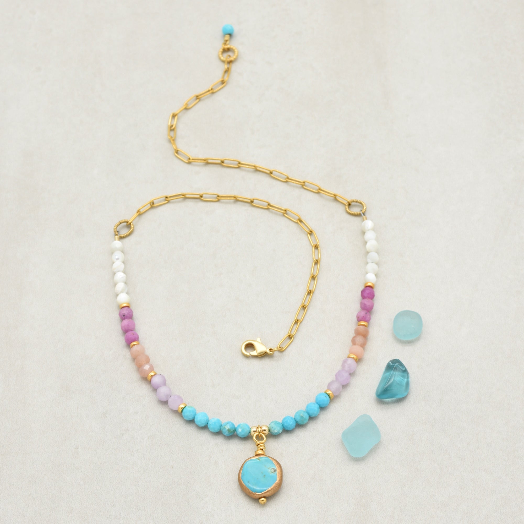 Multi gem gold chain choker necklace with genuine turquoise focal, kunzite, peach moonstone, and more on a light background - made with love by Ruby Acorn