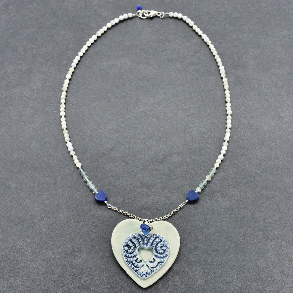 Necklace with a heart-shaped pendant on a gray background