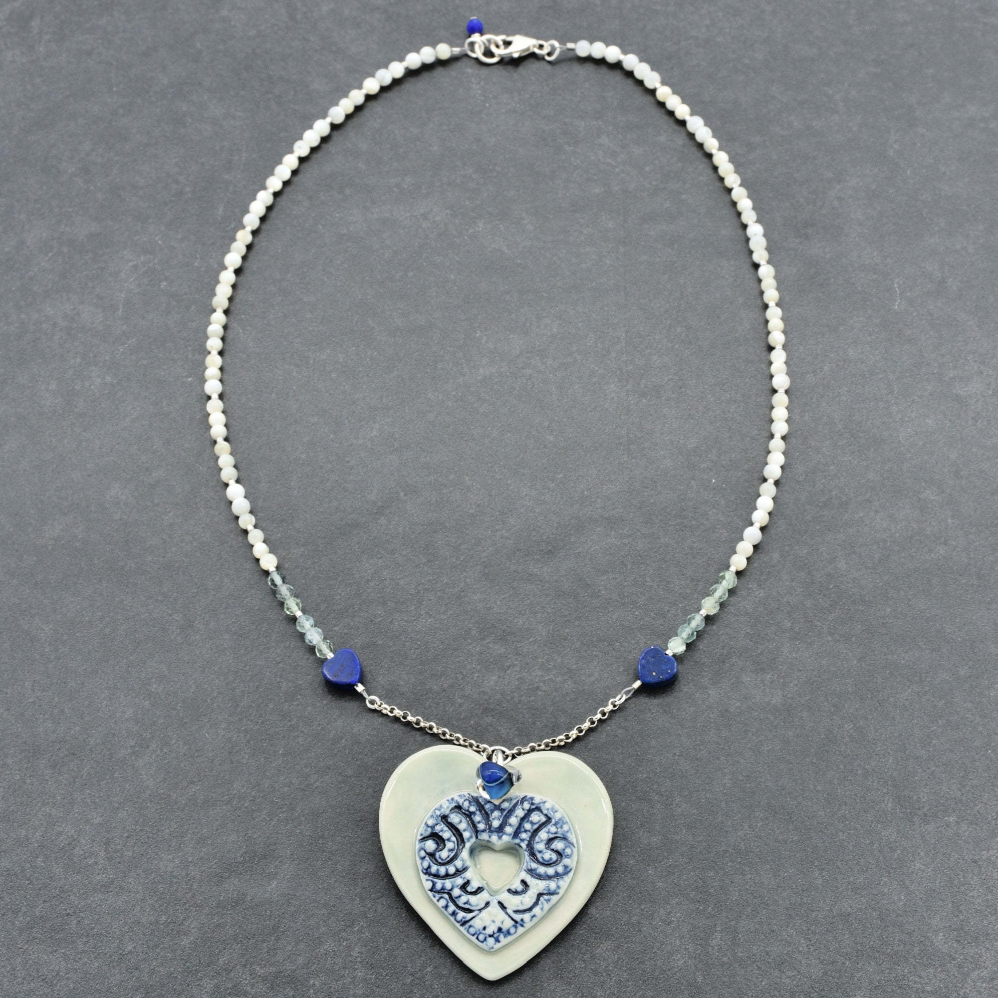 Necklace with a heart-shaped pendant on a gray background