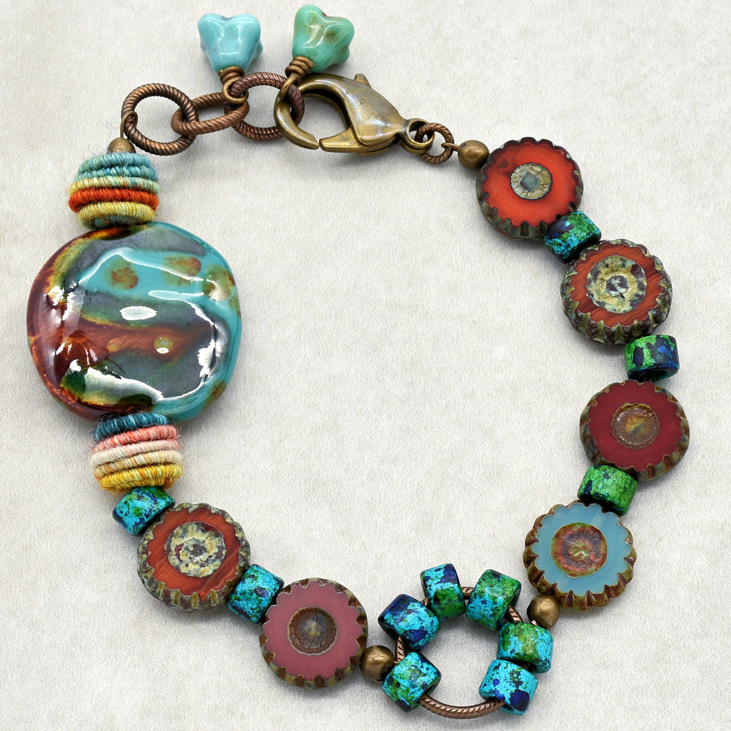 This image shows a bracelet. The jewelry piece is circular, relatively short in length, and features a clasp, which is common for bracelets. The colorful beads and segments are arranged in a pattern typical of bracelet designs.