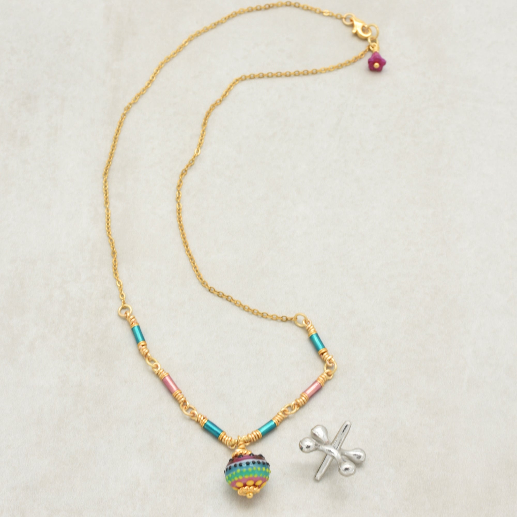 Gold chain necklace with colorful artisan lampwork glass focal and enamel tubes on a light background - art you can wear by Ruby Acorn