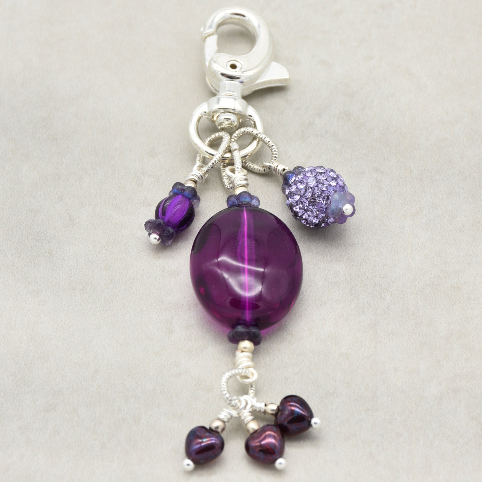 Violet Purple handbag charm with Lucite, pave and Czech glass hearts on a light background - handmade with love by Ruby Acorn
