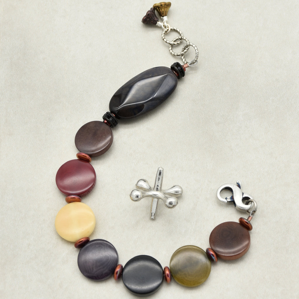 Bracelet with multicolored beads and silver clasp on a light background