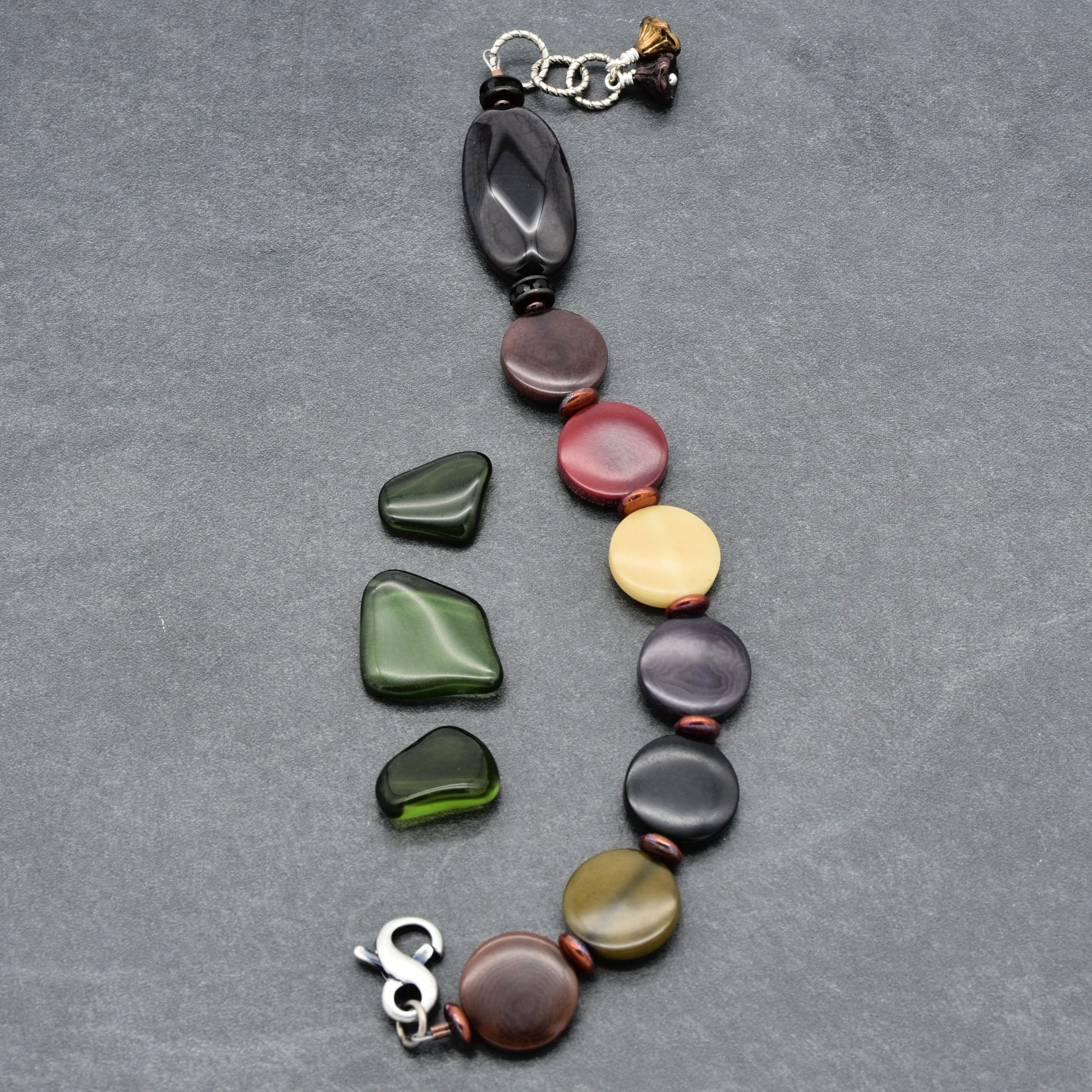 Bracelet with multicolored beads on a gray surface