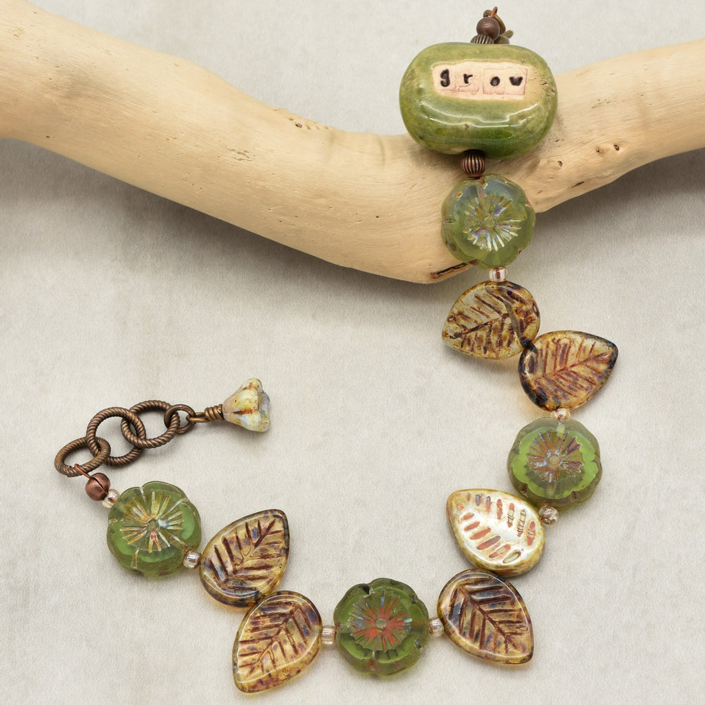 This image shows a bracelet. The jewelry piece is relatively short and has a clasp and chain on one end, which are typical features of a bracelet, distinguishing it from a necklace or an earring.