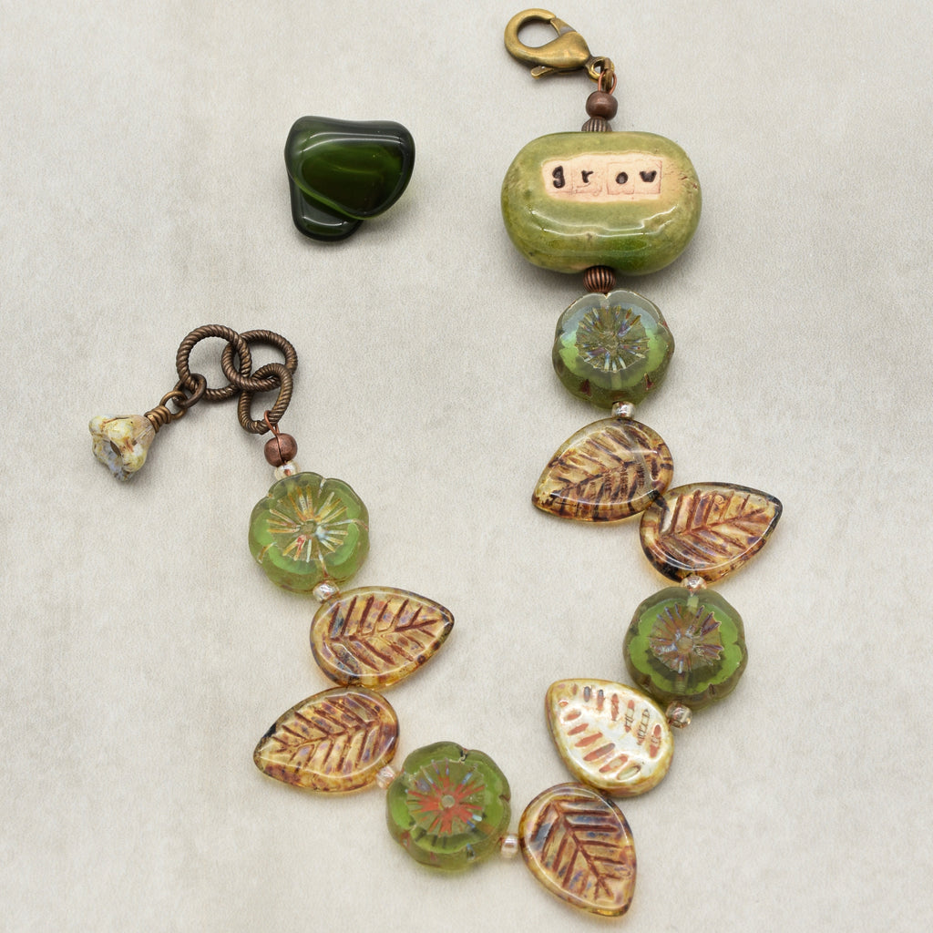 This image shows a bracelet. The item has a clasp that is typical for bracelets and is designed with beads and charms linked together, which is characteristic of bracelet jewelry.