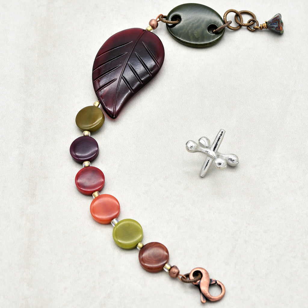 The jewelry in the image is a bracelet. The size, clasp, and arrangement of beads and decorative elements suggest that it is designed to be worn around the wrist.