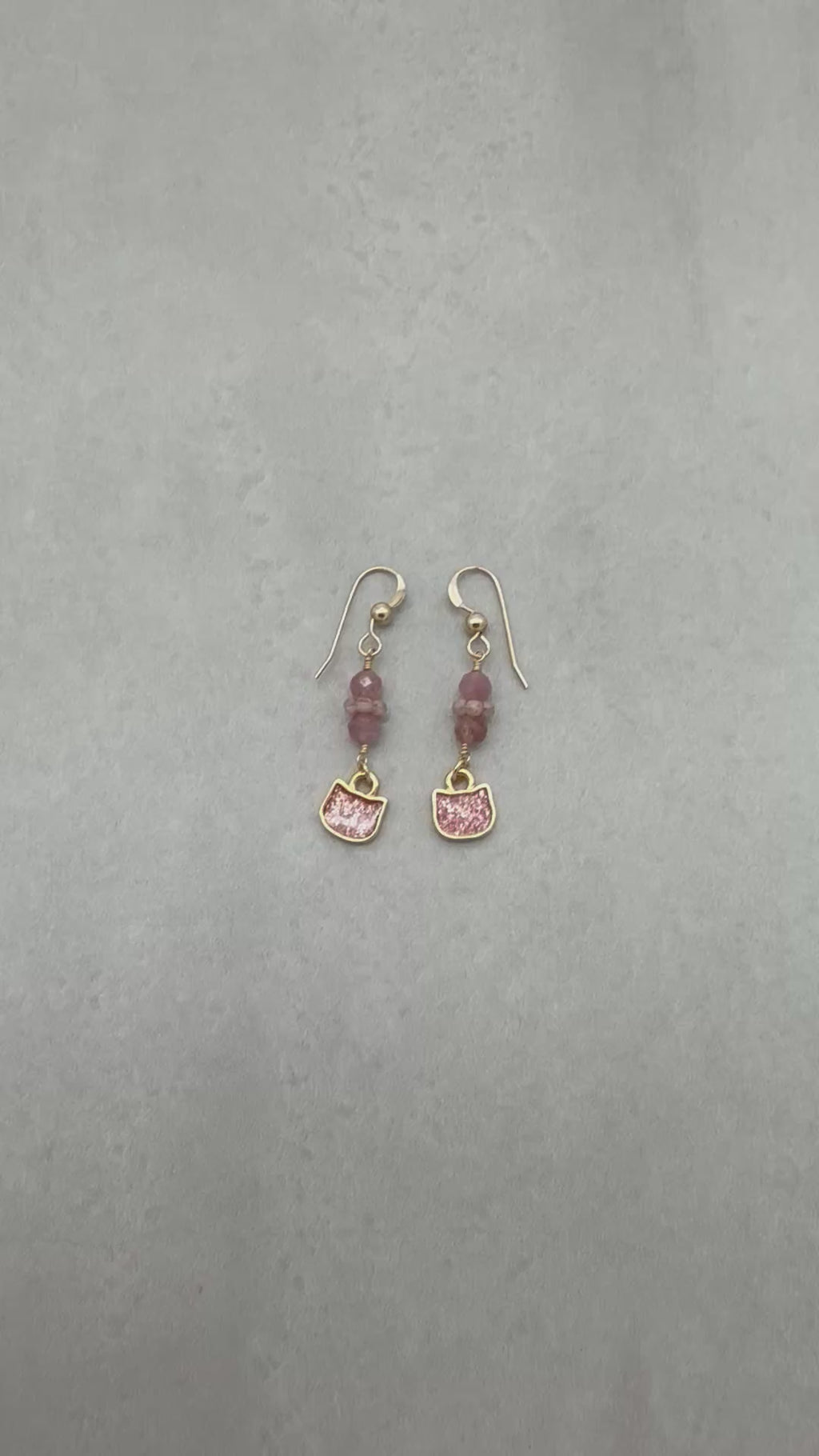 Video of lovely delicate pink dangle earrings with cat charms, pink tourmaline, and gold ear wires on a light background - handmade with love by Ruby Acorn